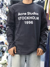 This long-sleeve black tee features bold typography and a relaxed, street-ready silhouette.