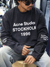 This long-sleeve black tee features bold typography and a relaxed, street-ready silhouette.